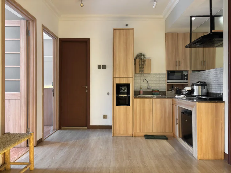 Nagoya: Dapur terbuka dengan kompor induksi, microwave, dan kulkas, dekat pintu kamar.