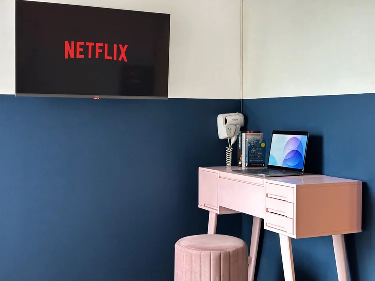 Montreal: Smart TV dengan Netflix di atas meja rias, hair dryer tergantung di dinding.