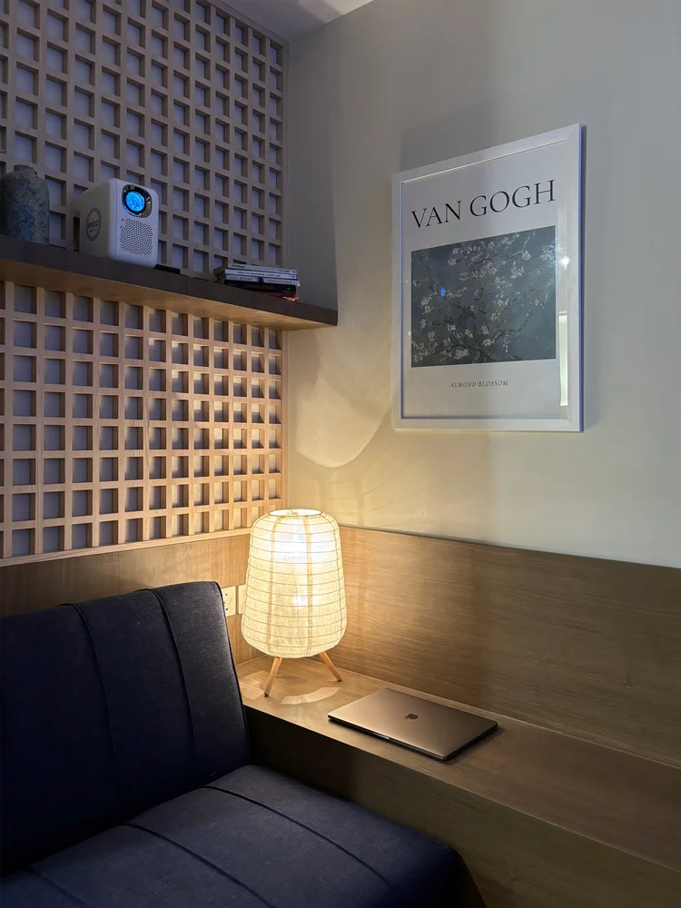 Aoyama: Sudut baca dengan lampu dan poster, di sebelah sofa.